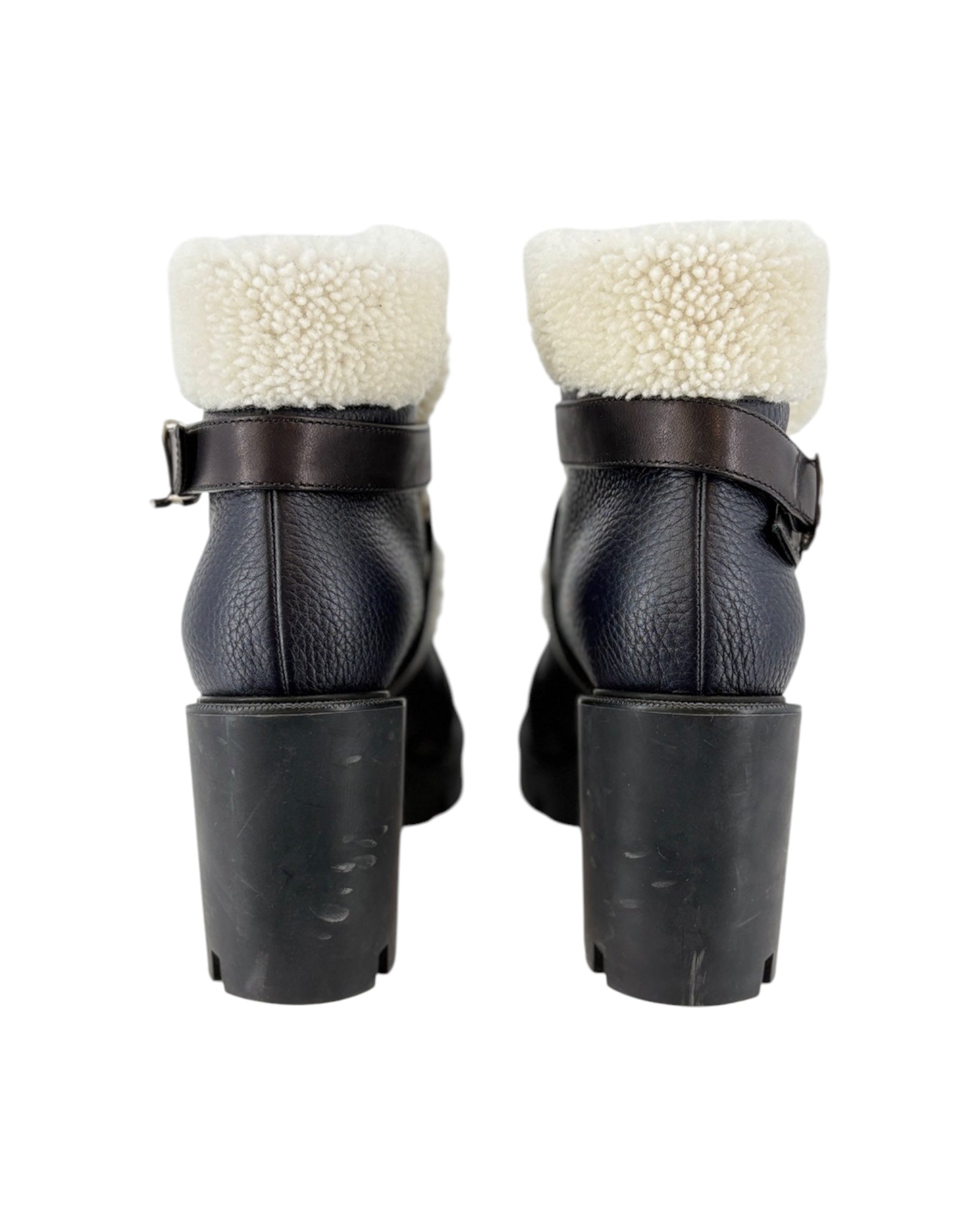 Black leather boots with white fur lining on a white background