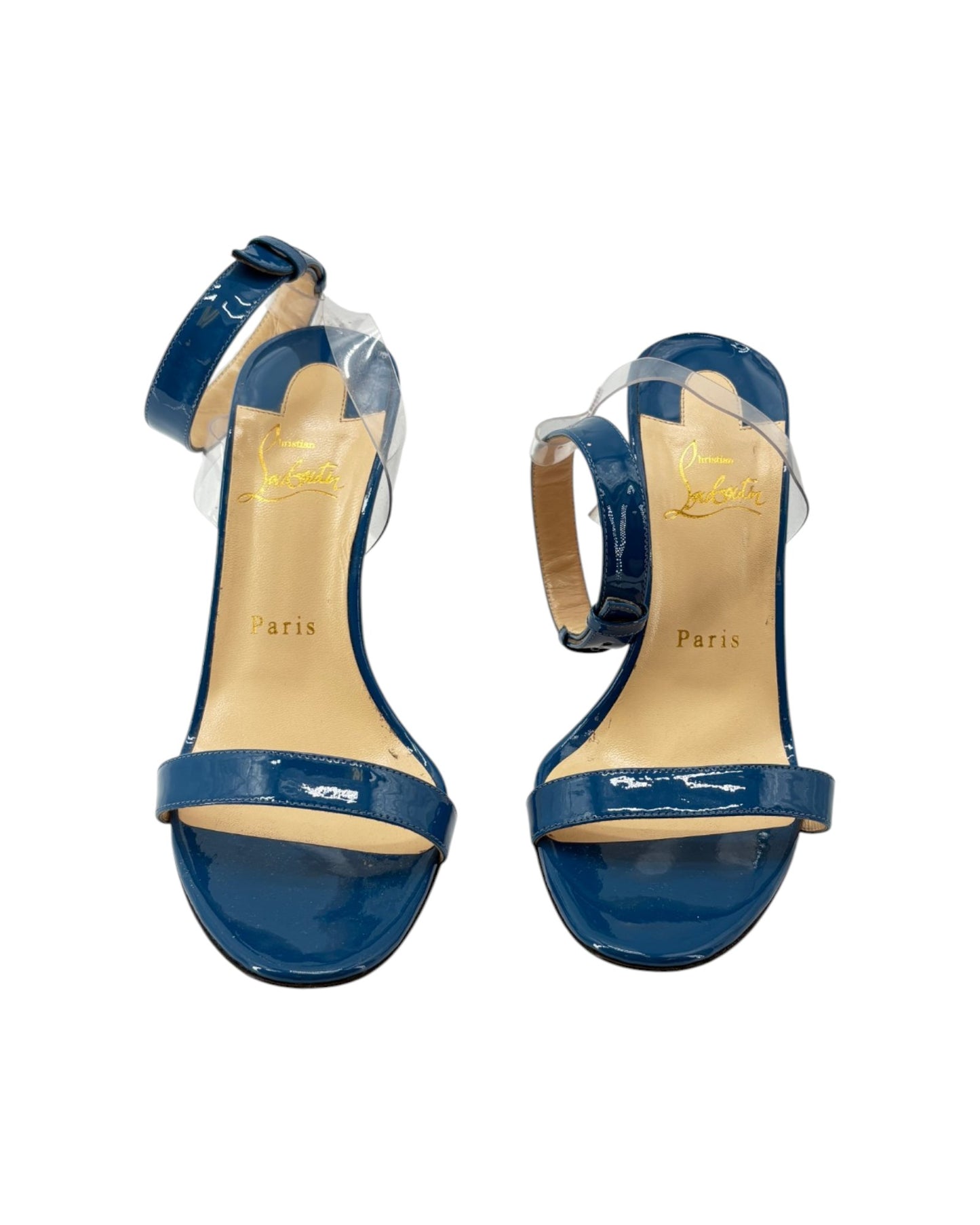 Blue high-heeled sandals with clear straps on a white background
