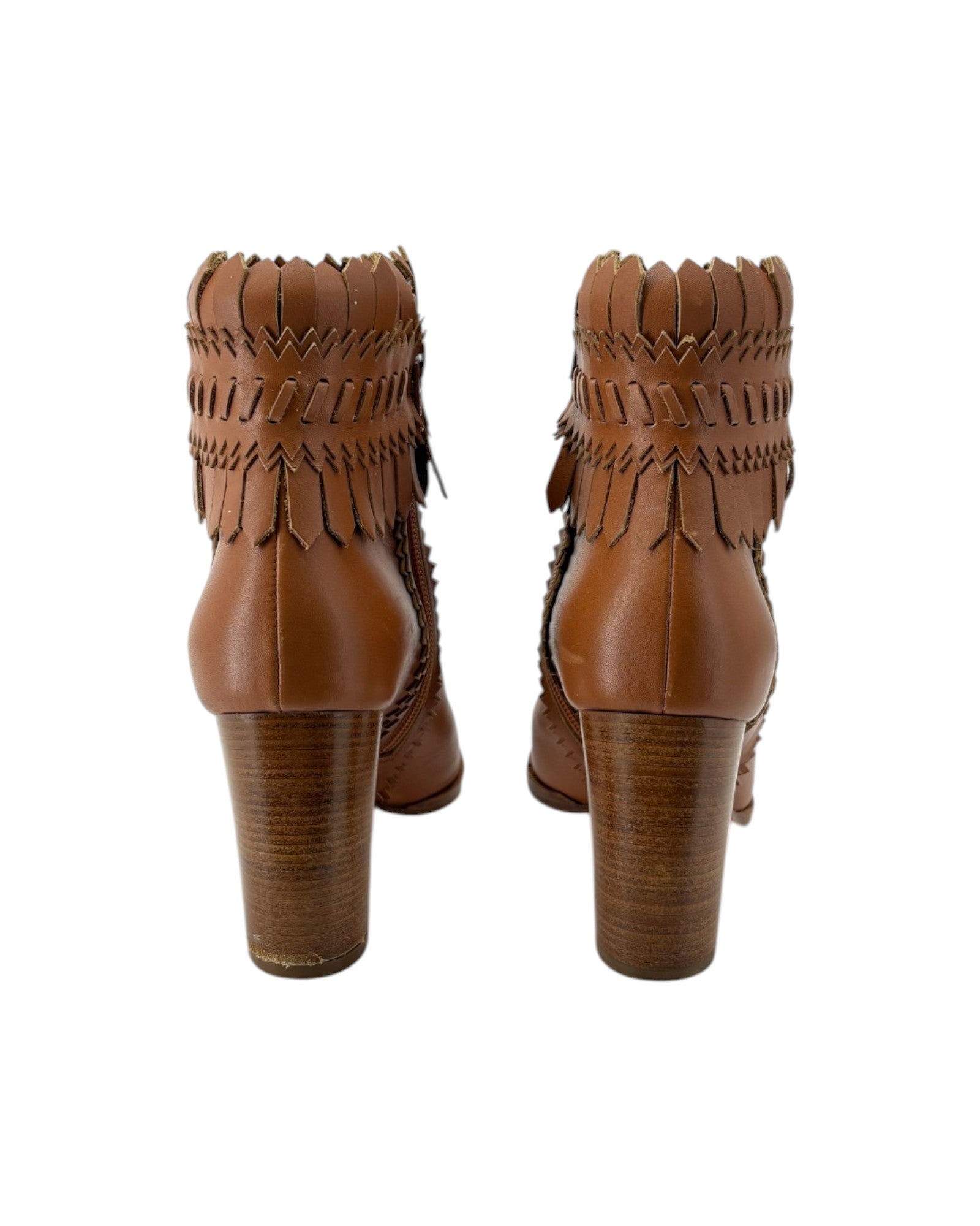 Pair of brown leather boots with fringe details on a white background