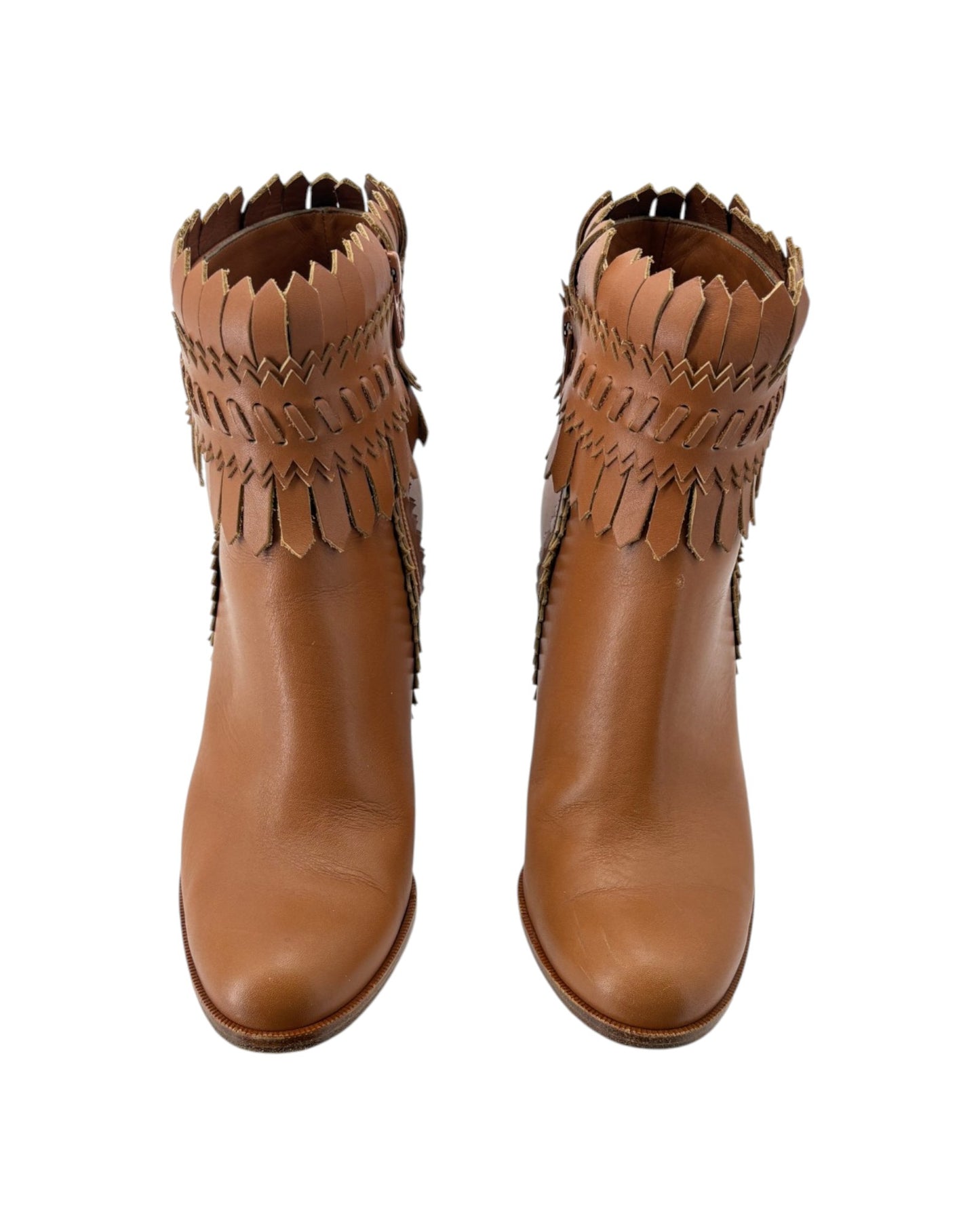 Pair of brown leather boots with fringe details on a white background