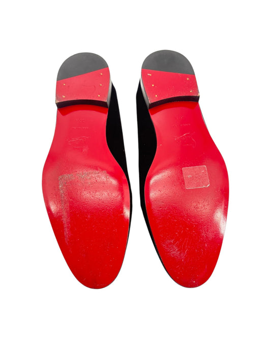 Red shoe soles with black tips on a white background