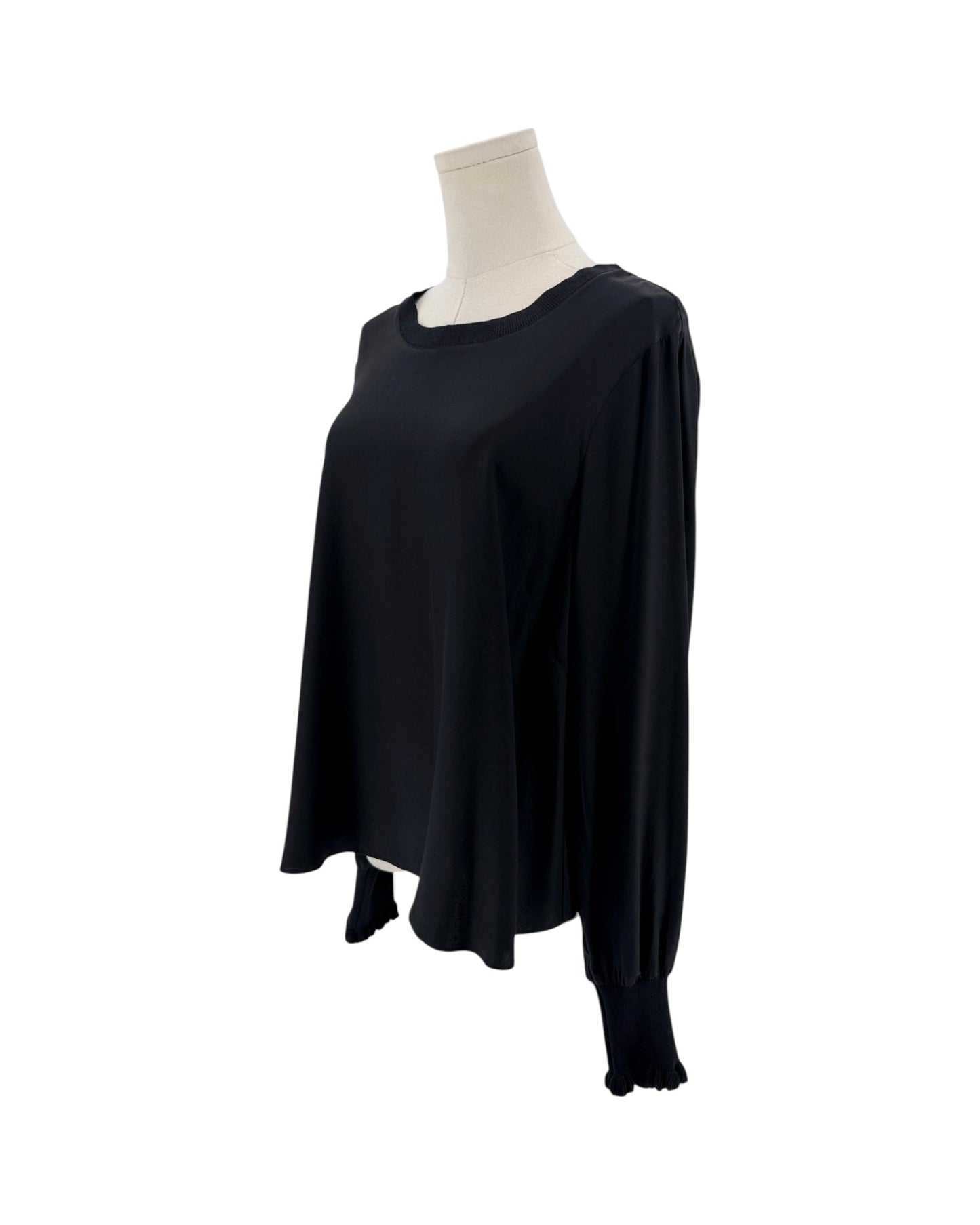 A black long-sleeve top displayed on a mannequin torso against a plain white background.