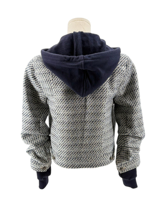 Back view of a textured sweater with navy hood on a mannequin against a white background
