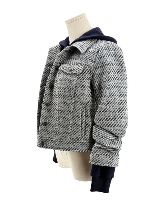 Houndstooth patterned jacket on a mannequin against a white background