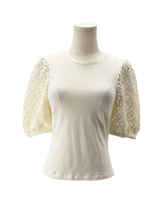 White top with lace sleeves on a mannequin against a white background