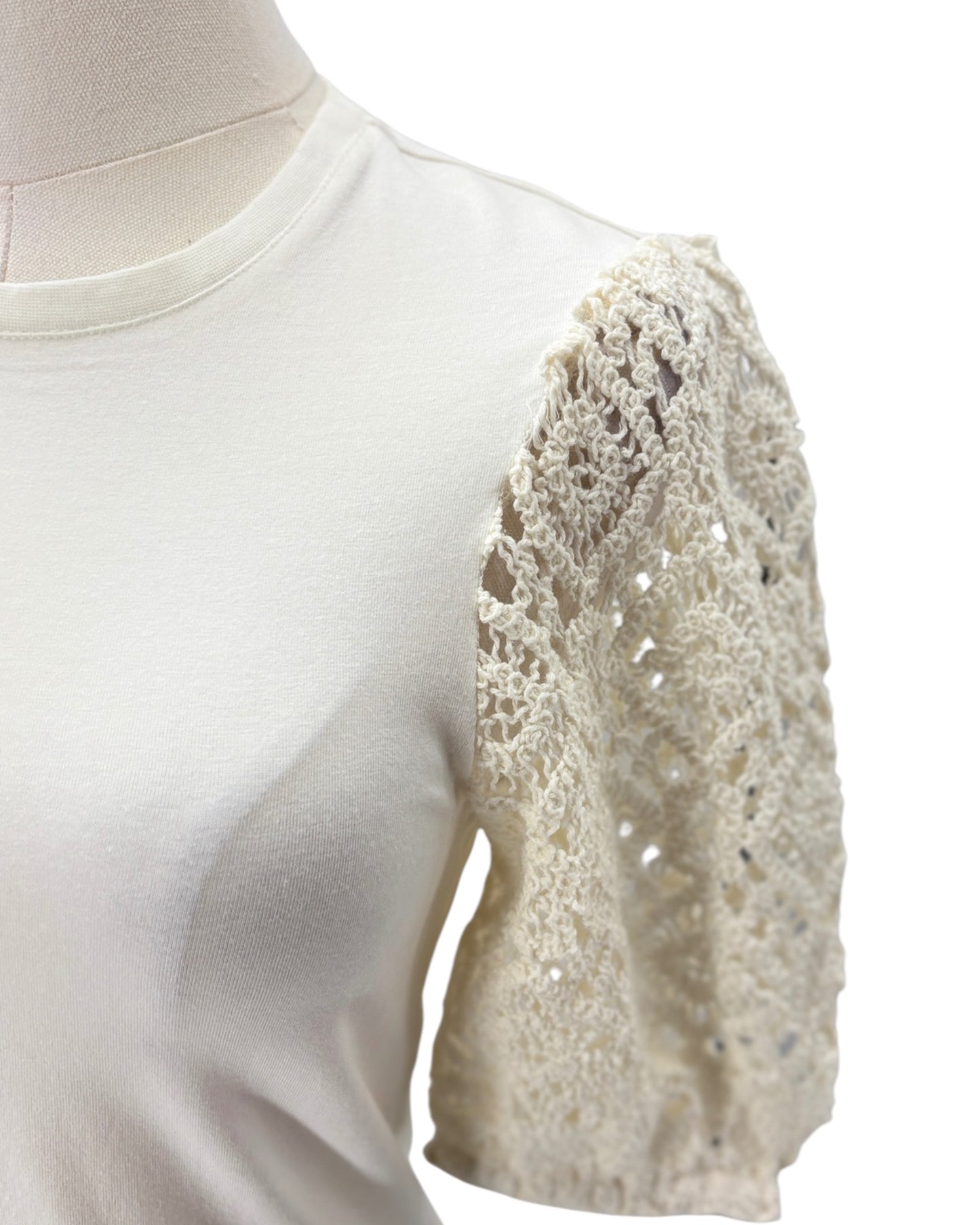 White blouse with lace sleeves on a mannequin