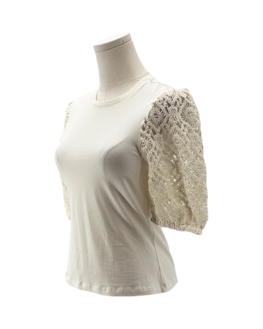 White t-shirt with lace sleeves on a mannequin against a white background