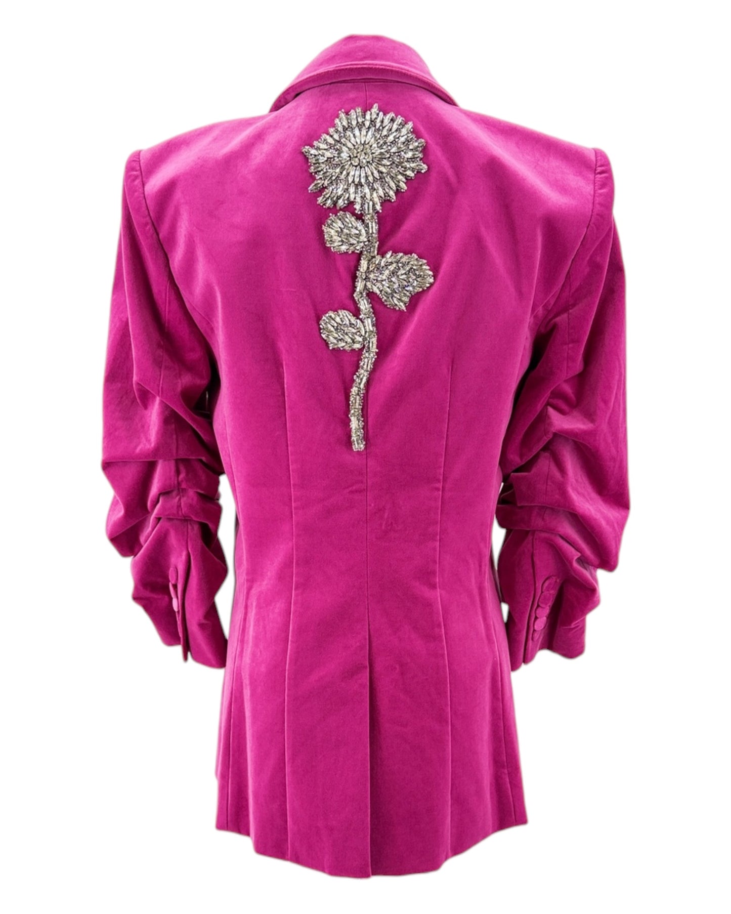 Pink blazer with a decorative silver flower on the back against a white background