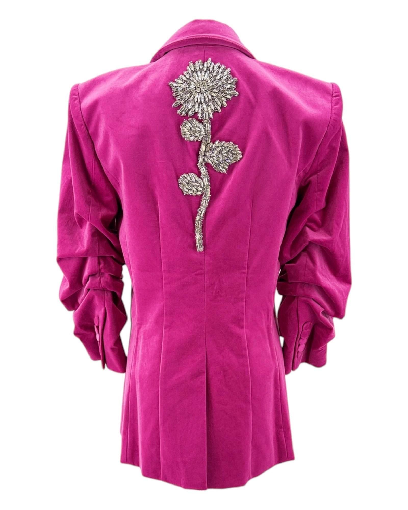 Pink blazer with a decorative silver flower on the back against a white background