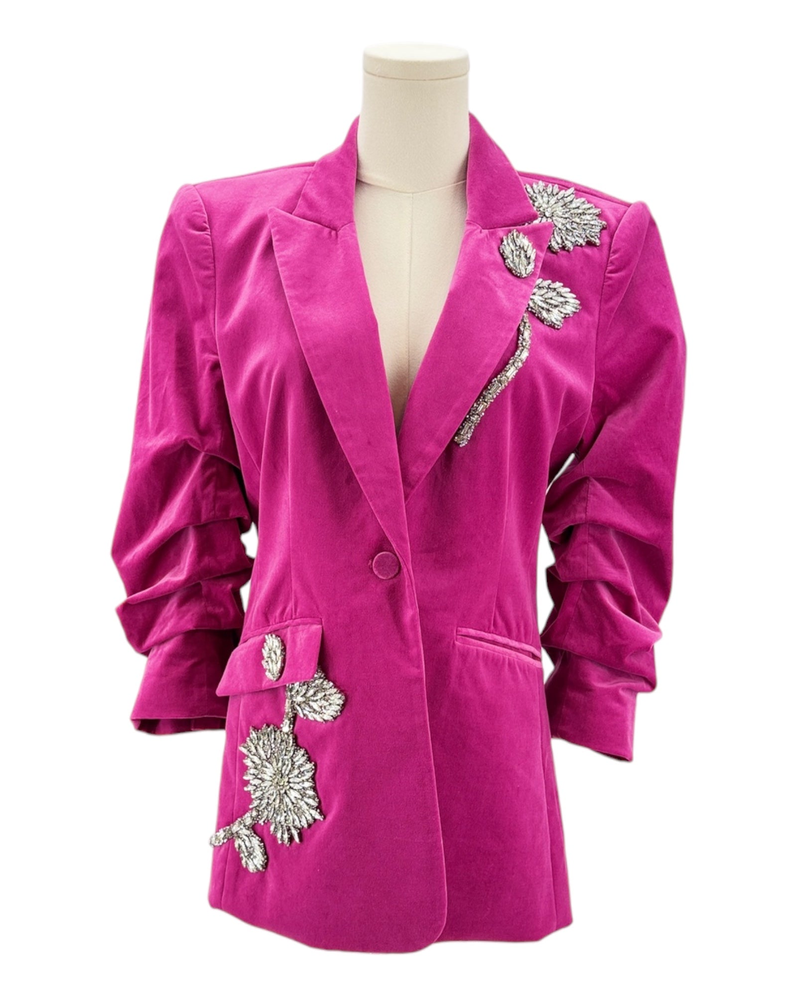 Pink blazer with silver embellishments on a mannequin against a white background