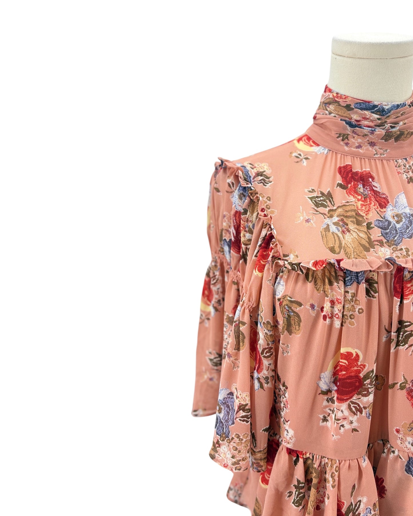 Floral dress on a mannequin against a white background