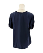 Cinq a Sept navy blue silk shirt on a mannequin against a white background