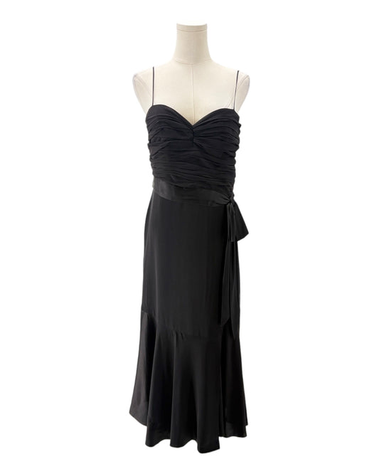 Black evening gown on a mannequin against a white background
