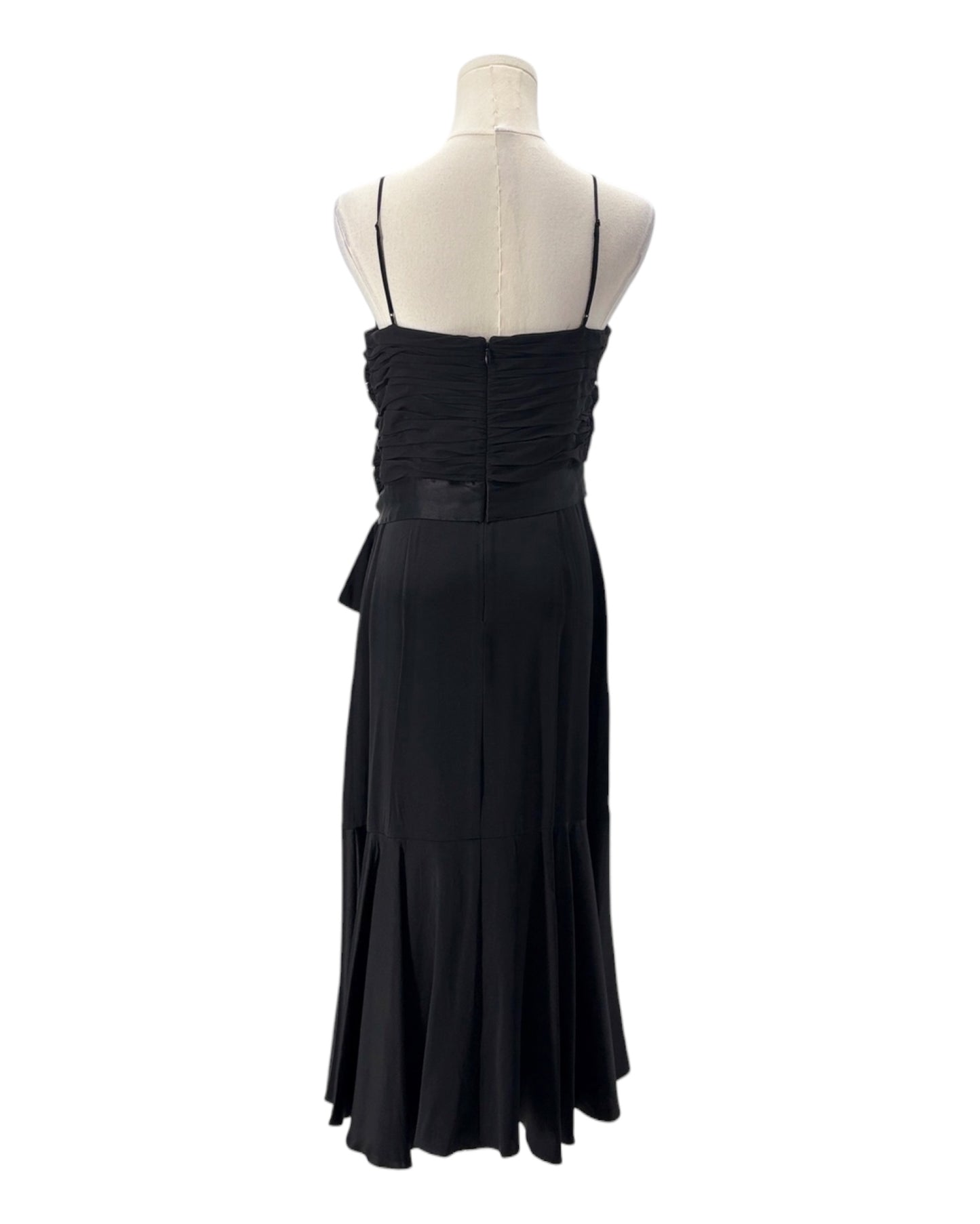 Black evening gown on a mannequin against a white background