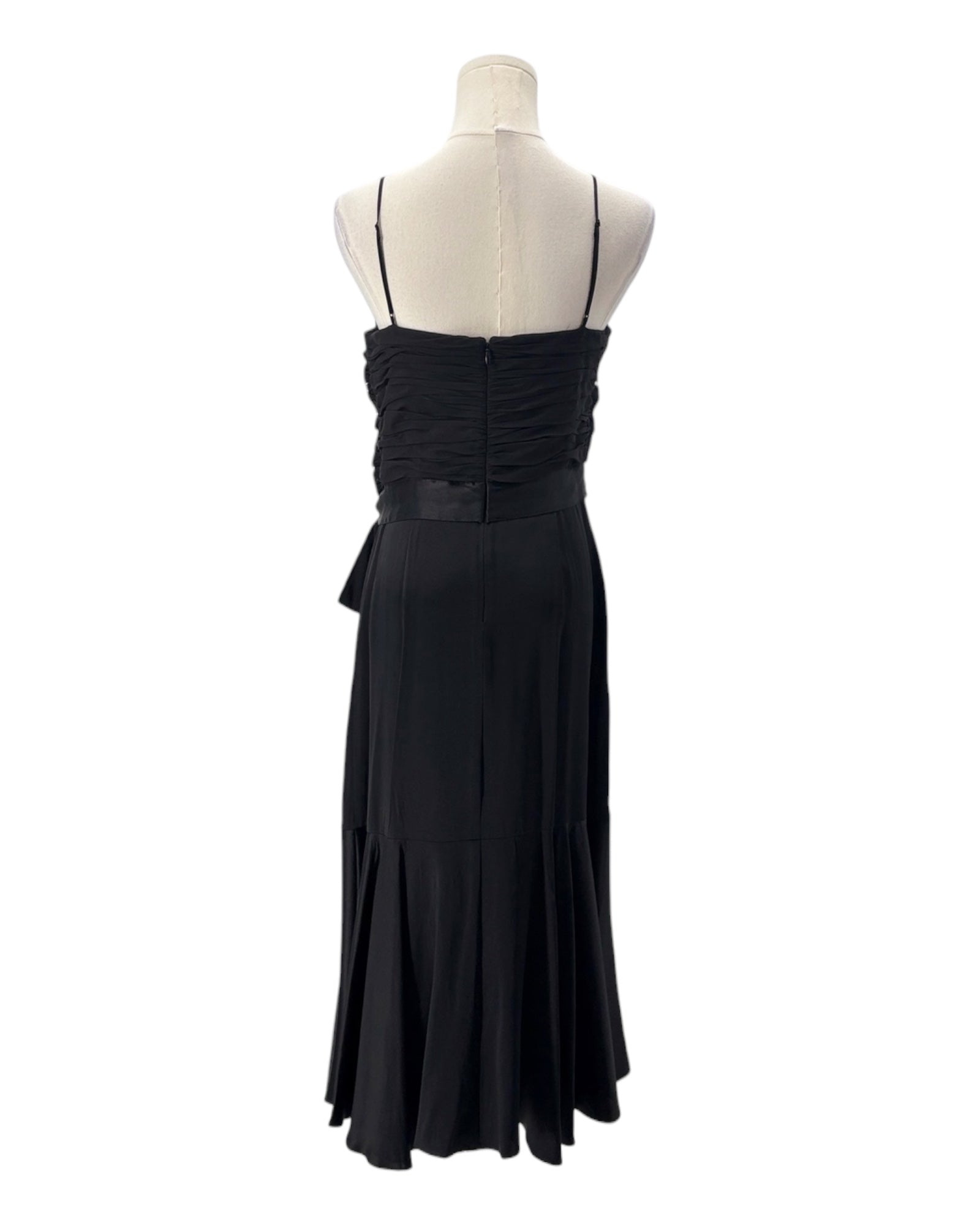 Black evening gown on a mannequin against a white background