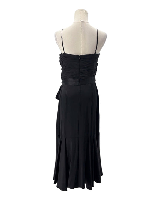Black evening gown on a mannequin against a white background