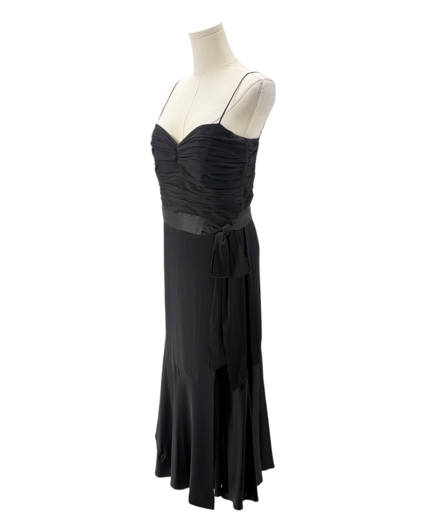 Black evening gown on a mannequin against a white background