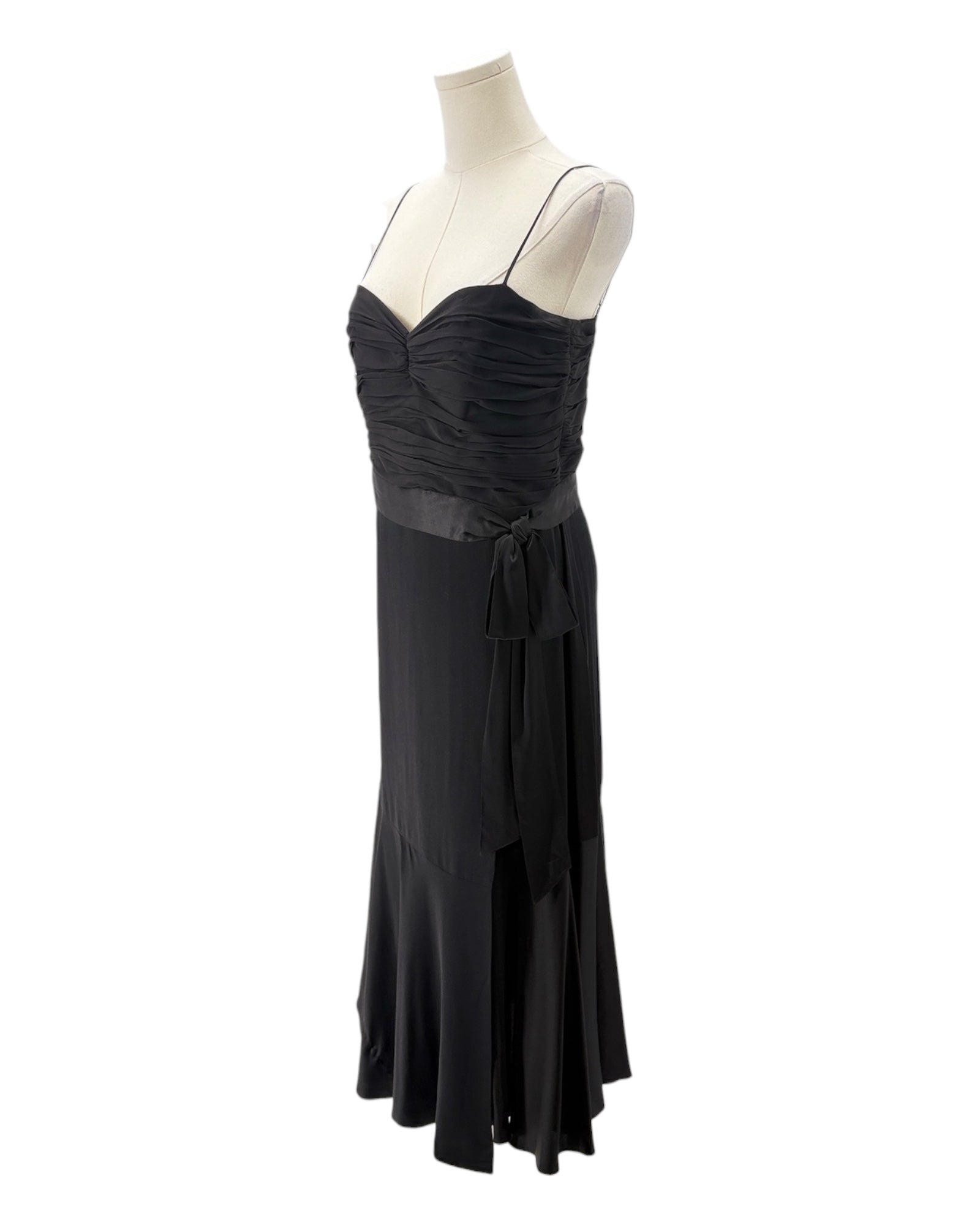 Black evening gown on a mannequin against a white background
