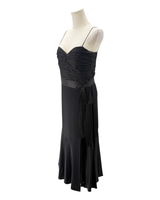 Black evening gown on a mannequin against a white background