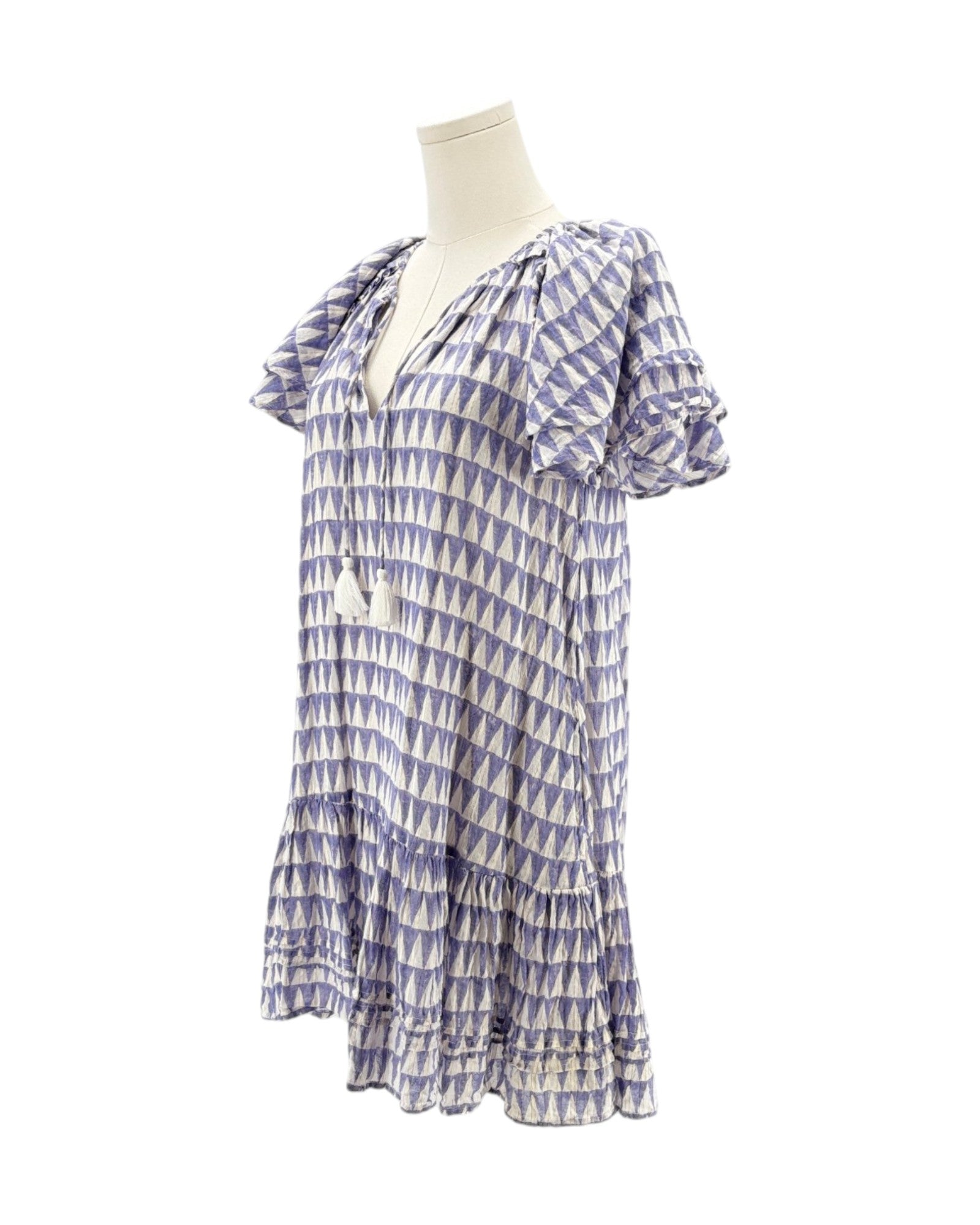 Blue and white patterned dress on a mannequin against a white background
