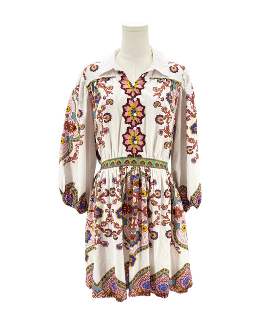 Floral dress on a mannequin against a white background