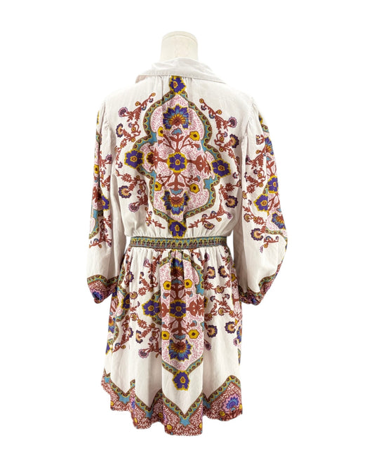 Colorful embroidered dress on a mannequin against a white background
