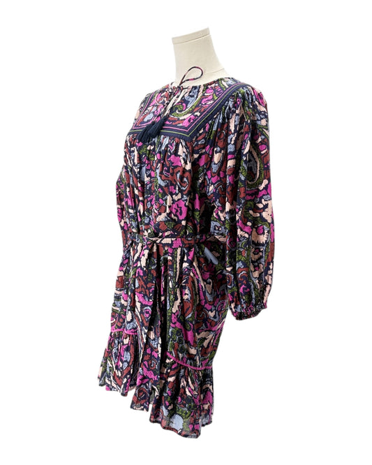 Colorful patterned dress on a mannequin against a white background