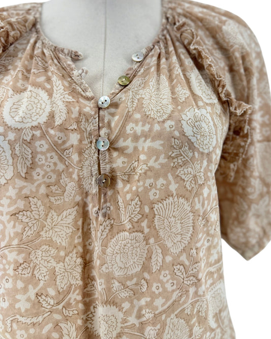 Tan and cream short sleeve floral print blouse on a mannequin on a white background