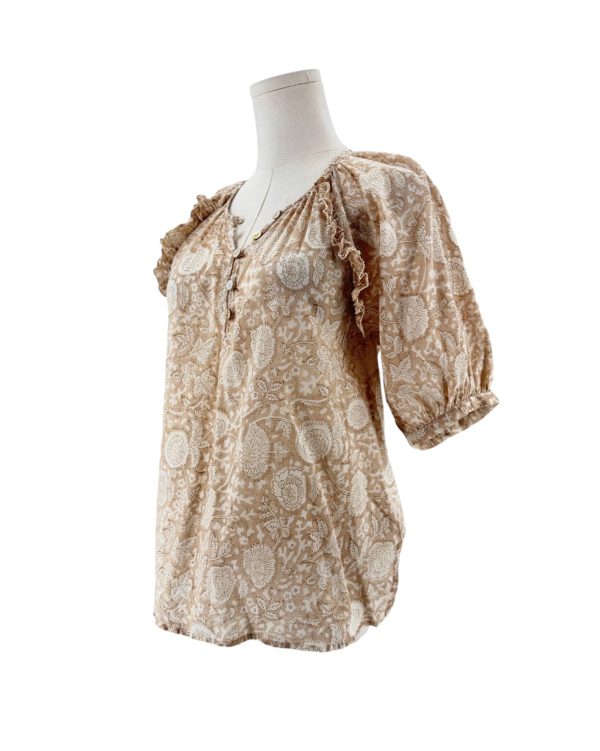 Tan and cream short sleeve floral print blouse on a mannequin on a white background