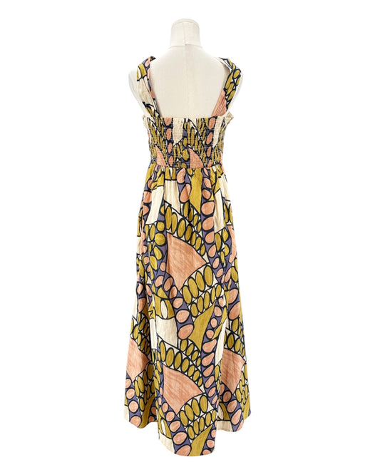 Colorful patterned dress on a mannequin against a white background