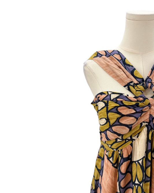 Mannequin wearing a colorful patterned dress on a white background