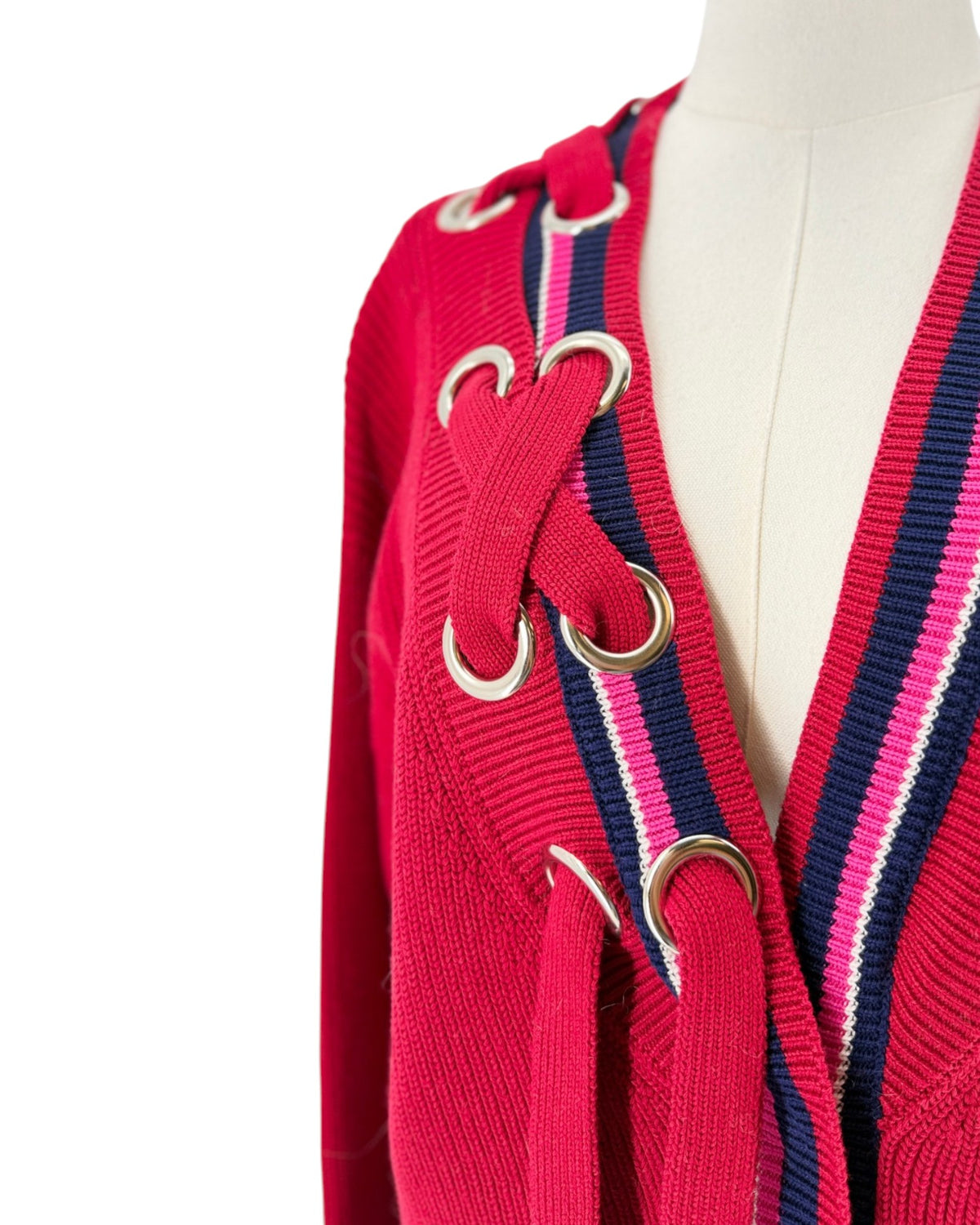 Color block cardigan with stripes and intricate detailing at the neckline. On a mannequin on a white background