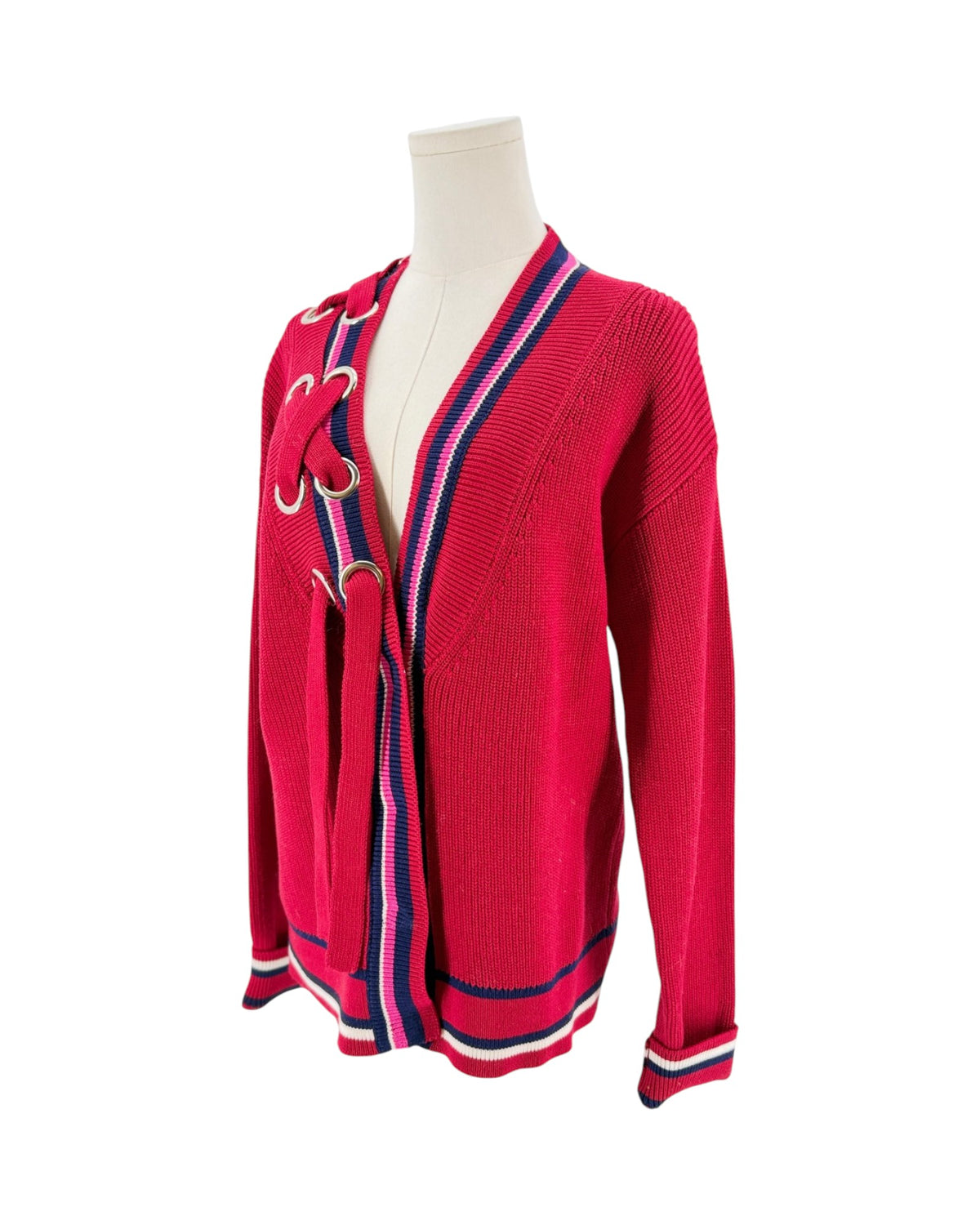 Color block cardigan with stripes and intricate detailing at the neckline. On a mannequin on a white background