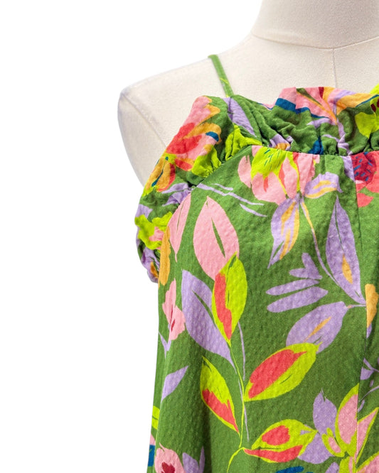 Colorful floral dress on a mannequin against a white background