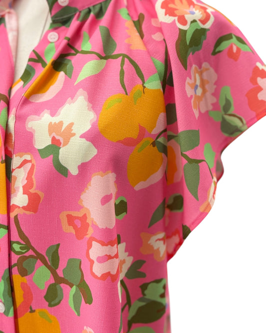 Close-up of a colorful floral and fruit pattern on a pink background
