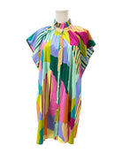 Colorful patterned dress on a mannequin against a white background