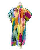 Colorful abstract patterned dress on a mannequin against a white background
