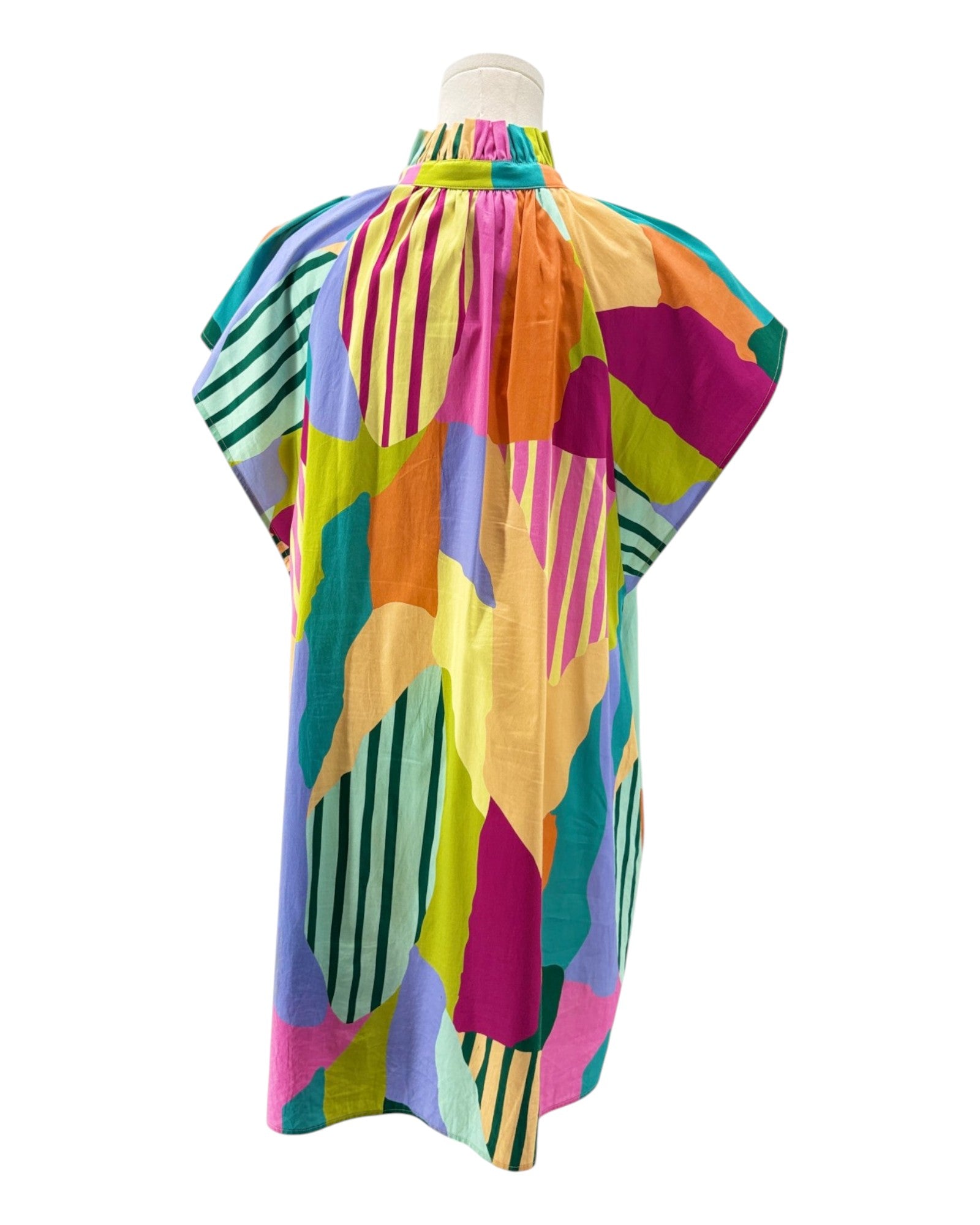 Colorful abstract patterned dress on a mannequin against a white background