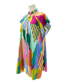 Colorful abstract patterned dress on a mannequin against a white background