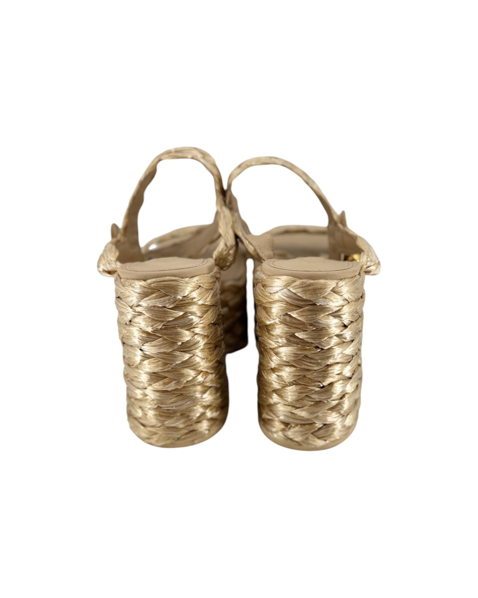A pair of women's strappy sandals with chunky woven block heels in a metallic gold finish, shown from a rear three-quarter view on a white background.