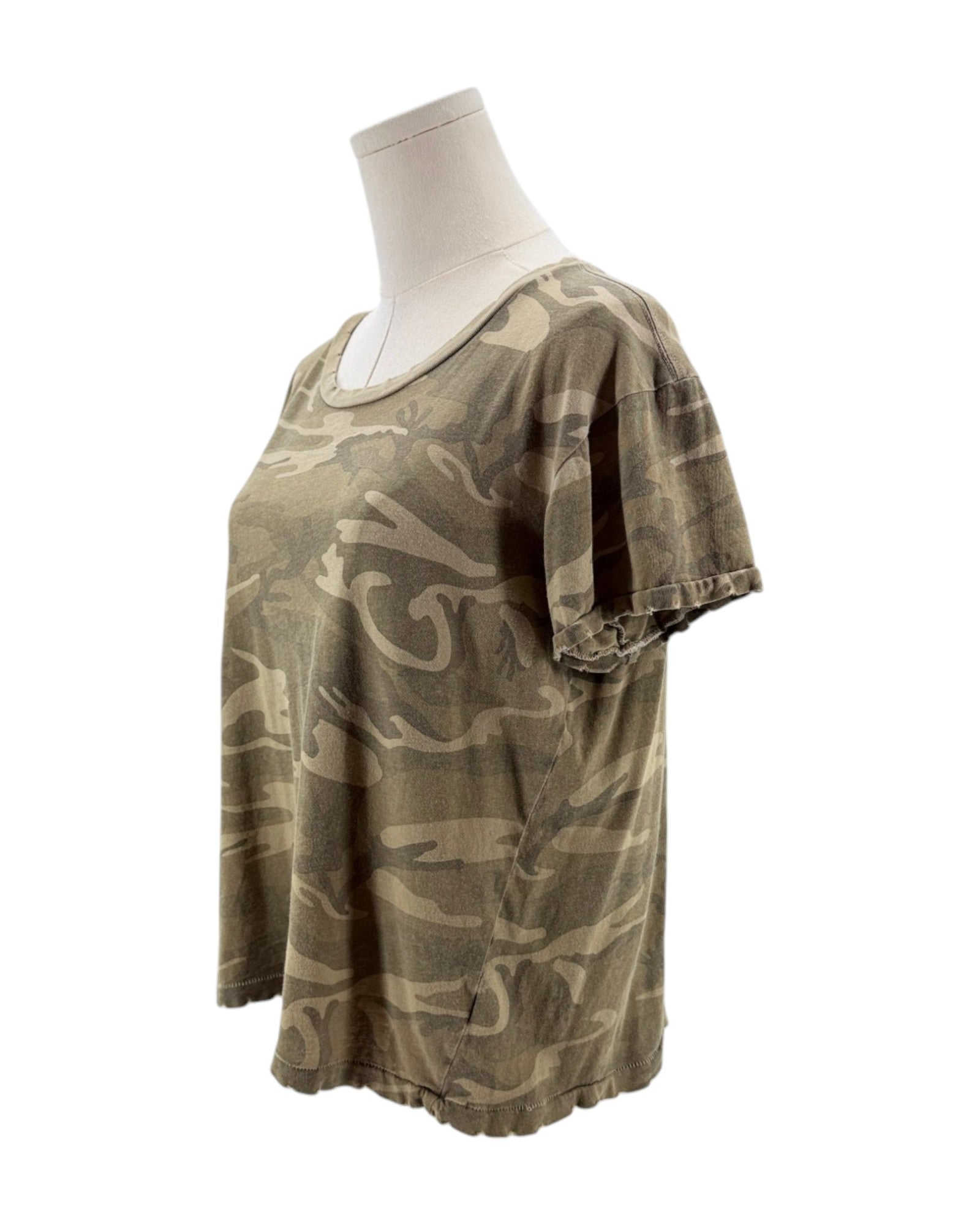 Camouflage-patterned t-shirt on a mannequin against a white background