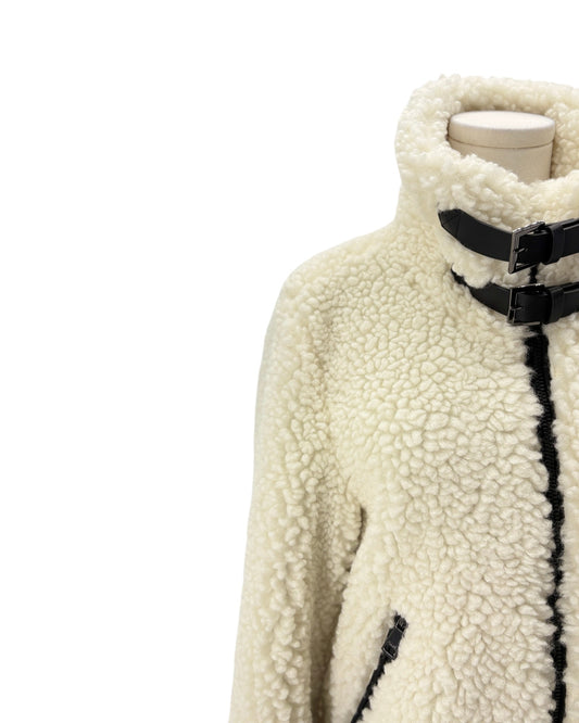 White sherpa jacket with black accents on a mannequin against a white background