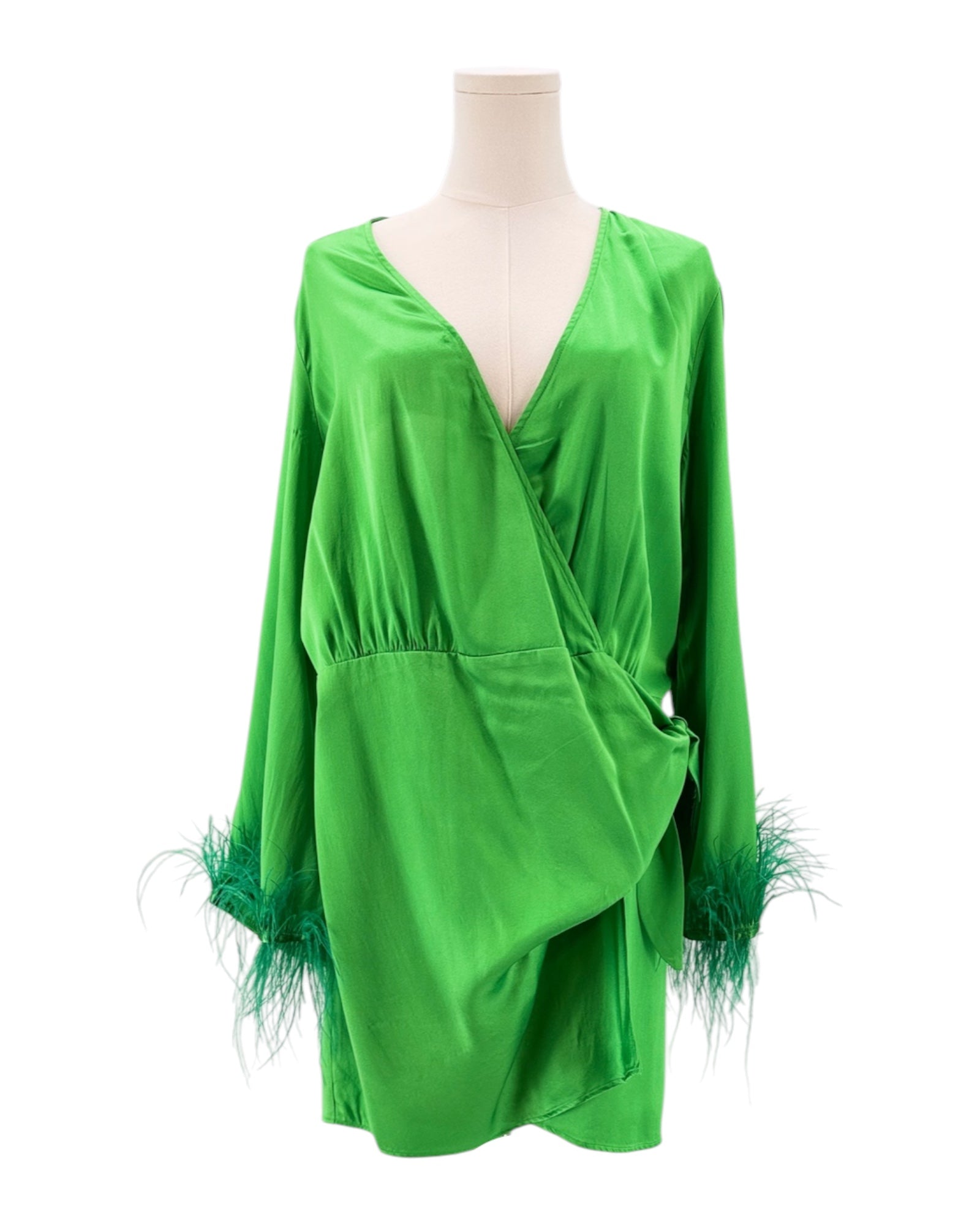 Green dress with feather details on a mannequin against a white background