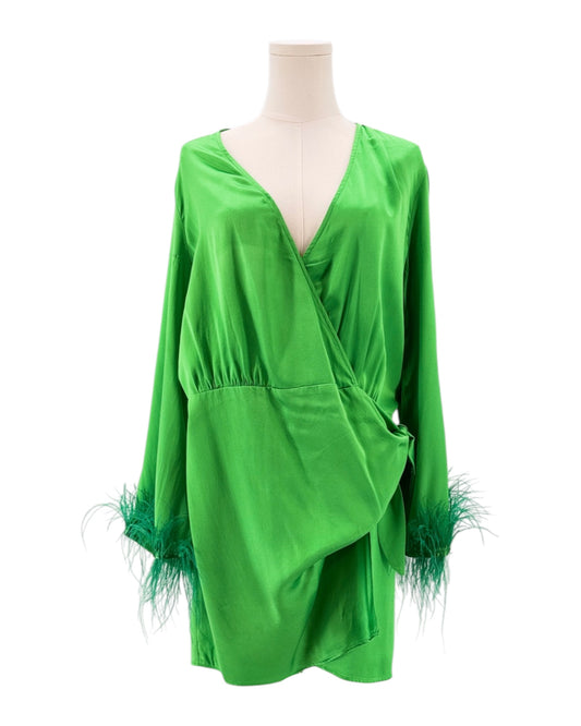 Green dress with feather details on a mannequin against a white background