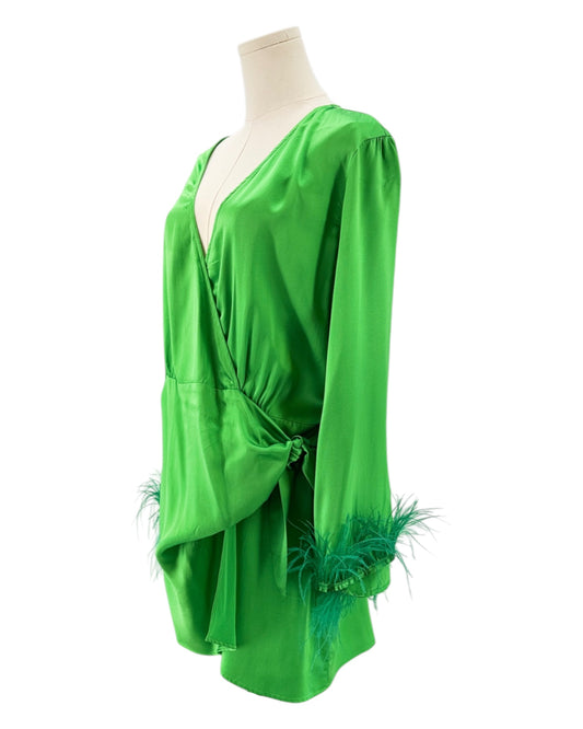 Green dress with feather details on a mannequin against a white background