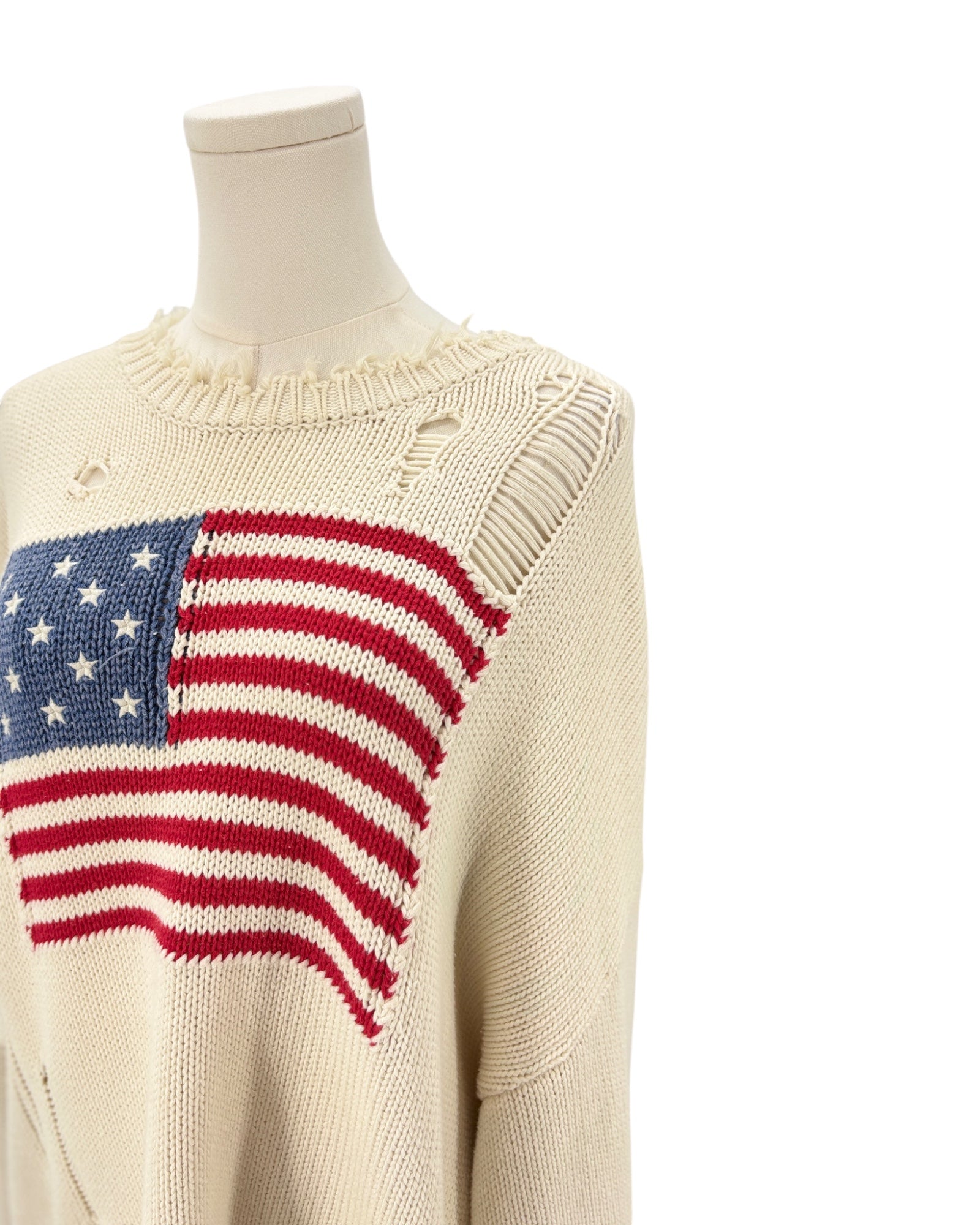 Denimist beige sweater with an American flag design on a mannequin against a background