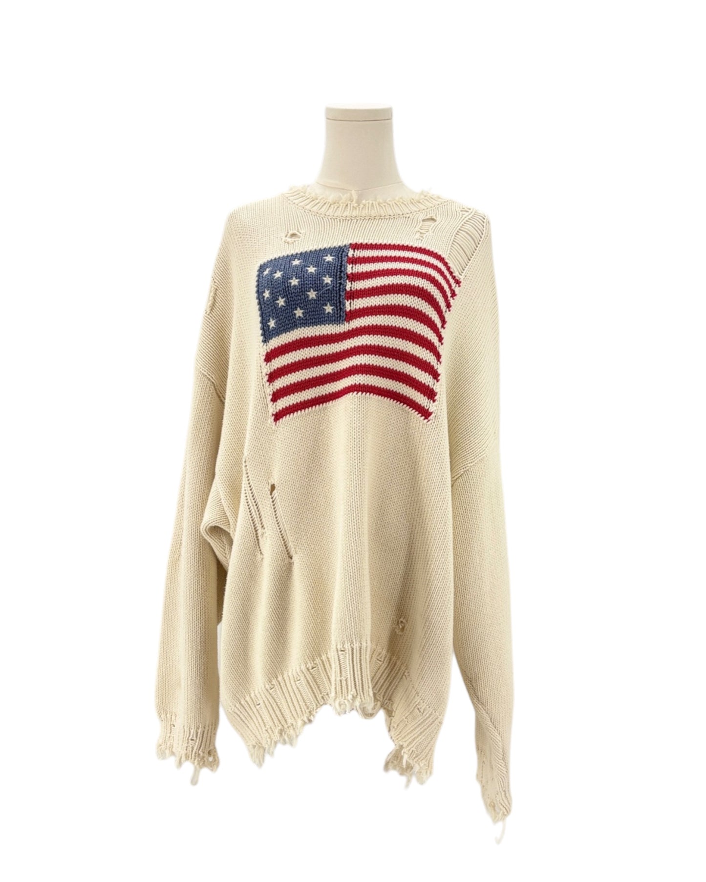 Denimist beige sweater with an American flag design on a mannequin against a background