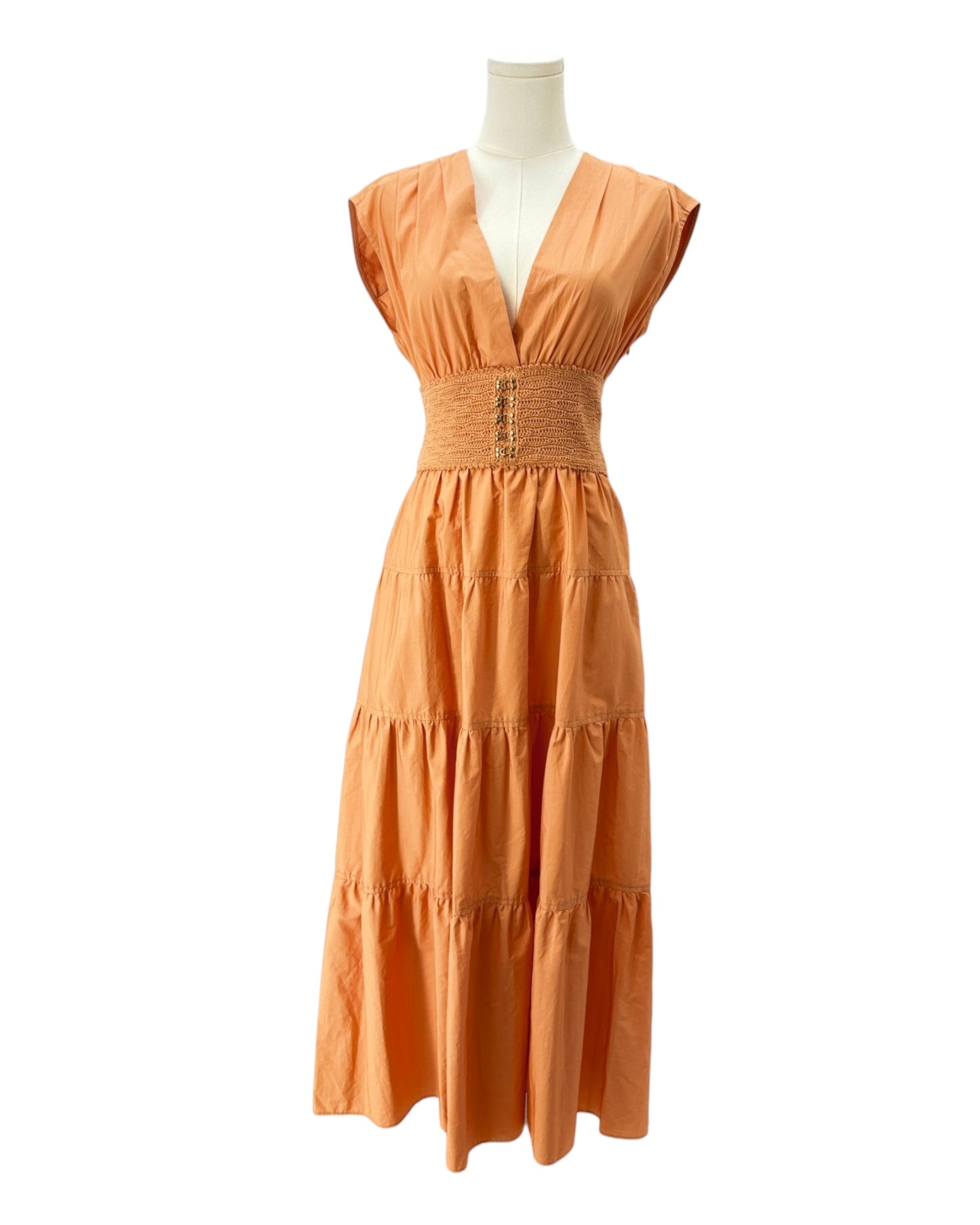 Orange dress on a mannequin against a white background