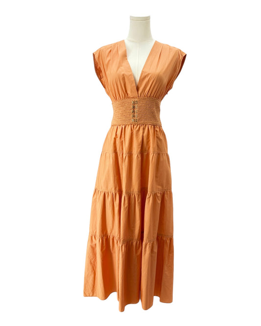 Orange dress on a mannequin against a white background