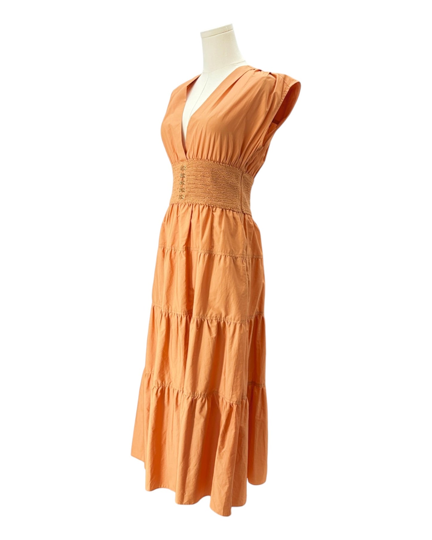 Orange dress on a mannequin against a white background
